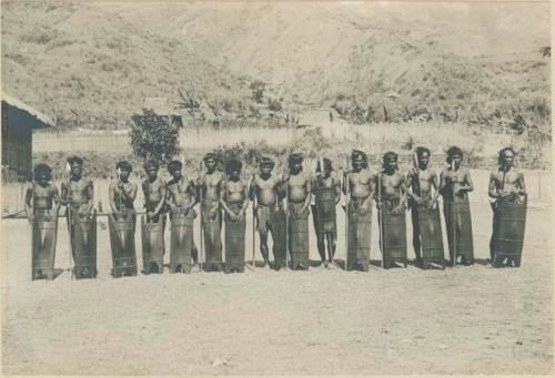 Group of Igorot warriors posed with lances, shields, and head-axes