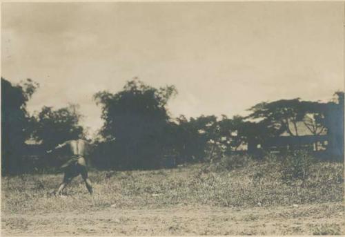 Igorot warrior throwing spear