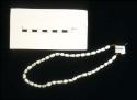 Sioux necklace. Striated tubular beads strung on cloth. 20.8x2.5 cm.