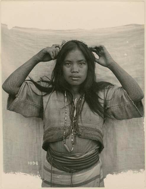 Suyoc Igorot girl showing tattooed arms. Taken at the St. Louis Exposition, 1904