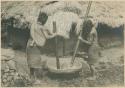 Igorot women grinding rice in mortar and pestle to make flour