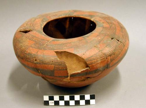 Ceramic jar, black on red exterior, mended, missing sherds