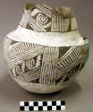 Ceramic complete jar, black-on-white, neck and handle broken, mended