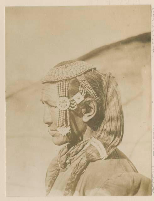 Woman with silver and coral head decoration