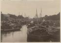 Boats docked on river