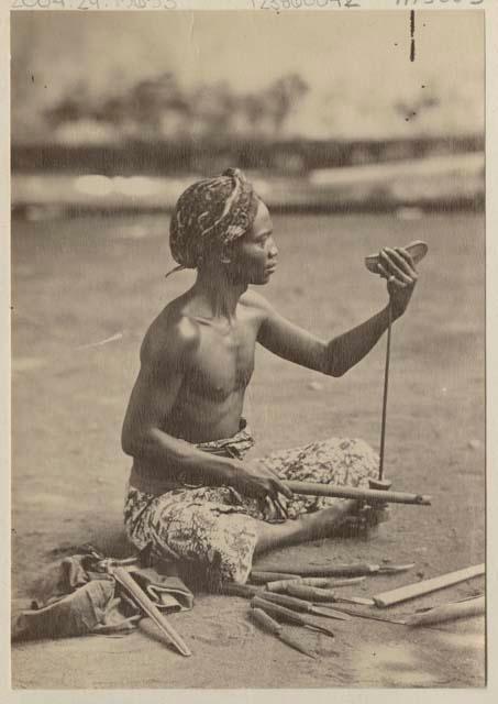 Man using wooden tools