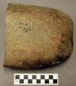 Metate fragment, fire-cracked. somewhat rectangular. fairly flat trough-like dep
