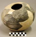 Ceramic sherds mended into partial jar, lightly patterned, reconstructed