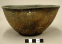 Small, deep, flat-bottomed, slightly flaring rimmed, mottled red and black ware
