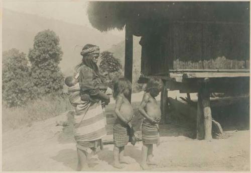 Igorot woman with her three children