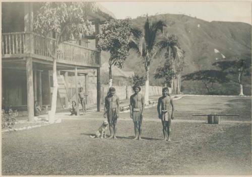 Igorot men and a dog in front of the provincial government building at Bontoc