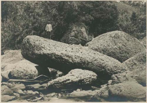 Benguet Igorot man standing on boulders in the river at Irisan