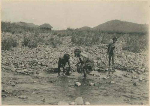Igorot children fishing in the stream at Trinidad