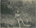 Benguet Igorot woman sitting on the bank of a stream
