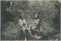 Two Benguet Igorot women sitting on the bank of a stream