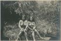 Two Benguet Igorot women sitting on the bank of a stream