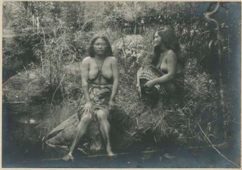 Two Benguet Igorot women sitting on the bank of a stream