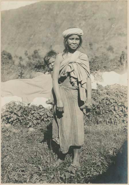 Igorot mother carrying baby on back