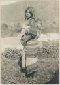 Igorot woman with child on her back