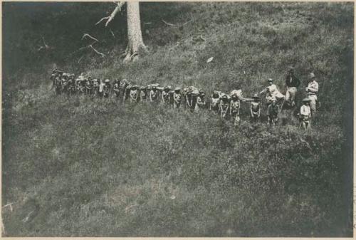 Igorot people carrying loads on the trail