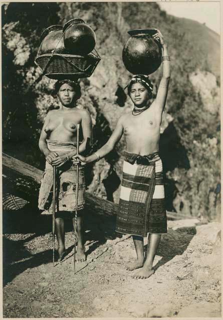 Two Igorot women with their finished pots to sell