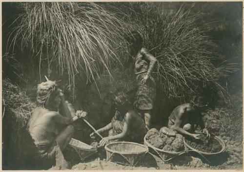 Igorot women collecting clay to make pottery