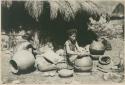 Igorot woman shaping rim of a pot