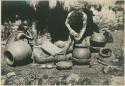 Igorot woman shaping rim of a pot