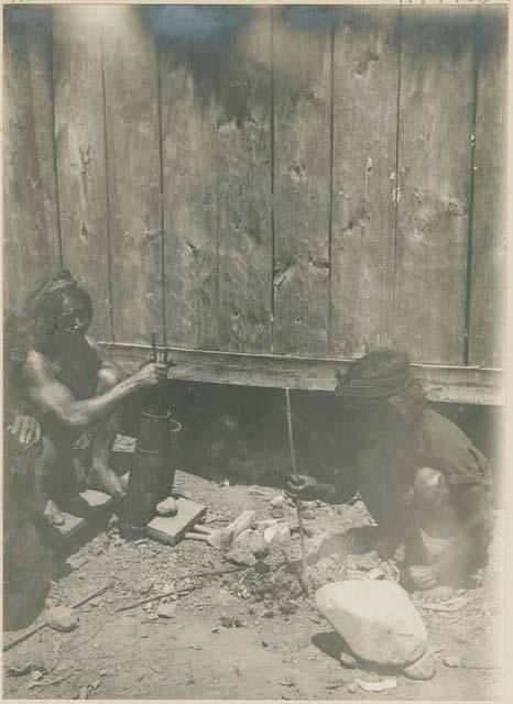 Igorot men making metal pipes