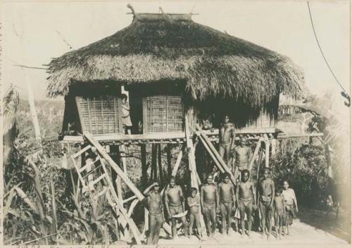 Ilongot community posing in front of a house