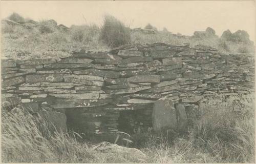 Stone house with two openings and ornamented door jambs