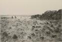 Men standing next to rock structure at La Perouse Bay