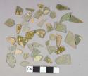 Light green flat glass fragments, some patinaed