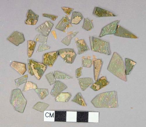 Light green flat glass fragments, some patinaed