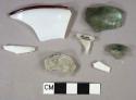 2 white milk glass vessel fragments, 1 rim fragment with red on edge of rim, 3 colorless vessel glas fragments, 1 patent finish, 2 olive green vessel glass fragments, 1 patent finish, 1 base kick up