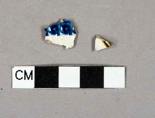 Lead glazed earthenware vessel body fragments, 1 fragment with blue and brown line decoration, 1 fragment blue shell-edged