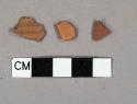 Unglazed redware vessel body fragment, 1 fragment with molded lines
