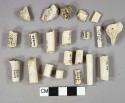 White kaolin pipe fragments, 11 Bowl fragments, 50 stem fragments, 4 with 4/64" bore diameter, 32 with 5/64" bore diameter, 7 with 6/64" bore diameter, 1 foot fragment with indistinct molded decoration, all other fragments undecorated