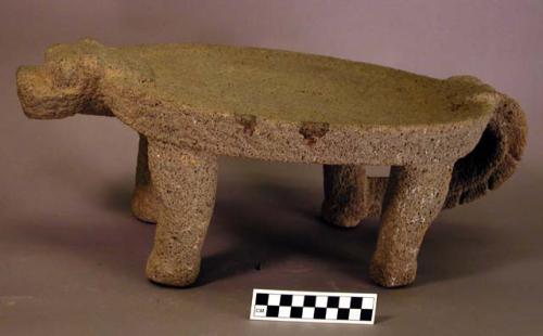 Ground stone animal effigy metate