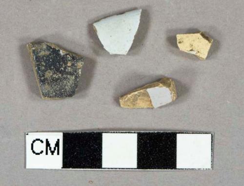 White tin glazed earthenware vessel fragments, 2 body fragments, 1 rim fragment, 1 heavily burned (glaze refired black and bubbly)