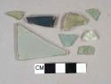 Aqua glass fragments, 1 flat glass fragment, 1 painted black or heavily burned