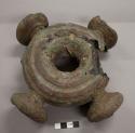 Metal ring, nitien, cast brass with clay core; four knobs;  top of one knob missing, cracks in ring, casting flaw