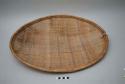 Large basketry plate - wicker weave, oval shape, coiled rim, stripes of cerise a