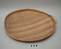 Large basketry plate - wicker weave, oval shape, coiled rim, stripes of cerise,
