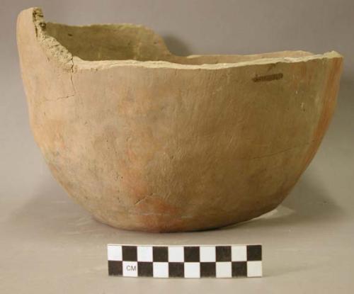 Ceramic partial bowl, plain exterior with red slip , base and rim sherds missing