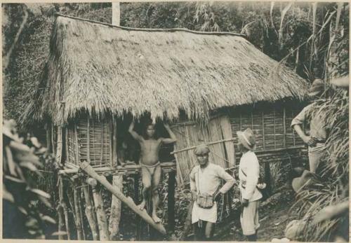 Men in front of lower class Ilongot home