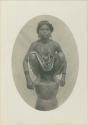 Young woman posed squatting on a rice mortar