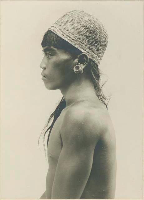 Profile of young Kalinga Warrior wearing basket hat