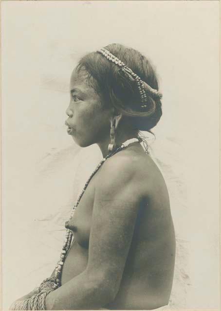 Profile of a young Kalinga girl wearing traditional Kalinga earrings