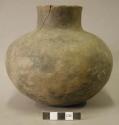 Ceramic vessel, short neck, cracked.